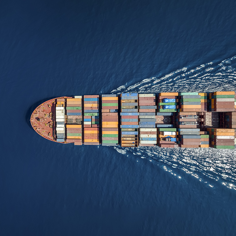 A cargo ship is sailing over open ocean